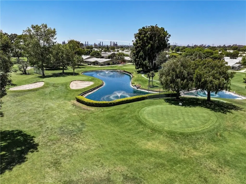 18-hole golf course at Leisure World Seal Beach featuring lush greens, water features, and surrounding trees, promoting active living and leisure pursuits for residents.