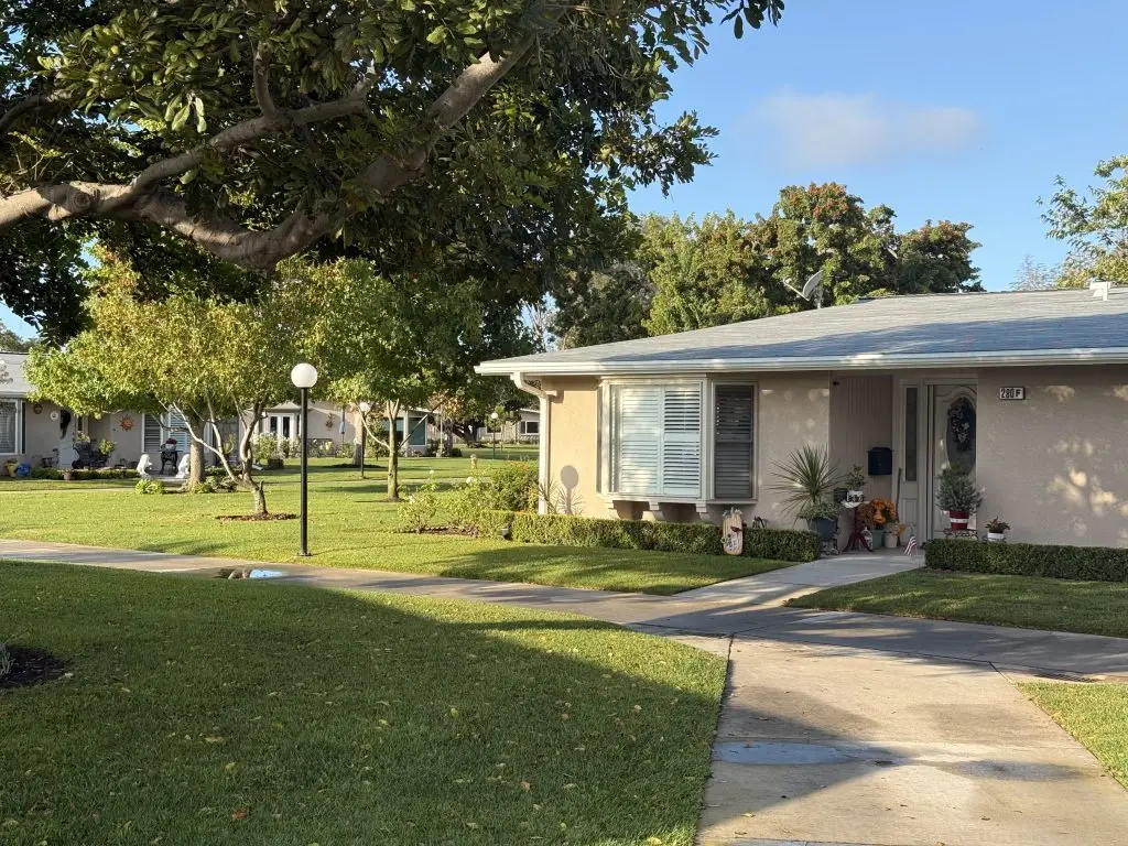 Residential community at Leisure World Seal Beach, featuring well-maintained homes, green lawns, and pathways, promoting active living and social engagement for older adults.