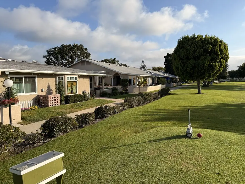 Community residences at Leisure World Seal Beach, featuring well-maintained lawns, pathways, and outdoor amenities, promoting social interaction and wellness activities.