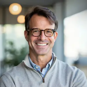 Smiling man in a light sweater, representing real estate expertise and community connection in the Leisure World Seal Beach area.