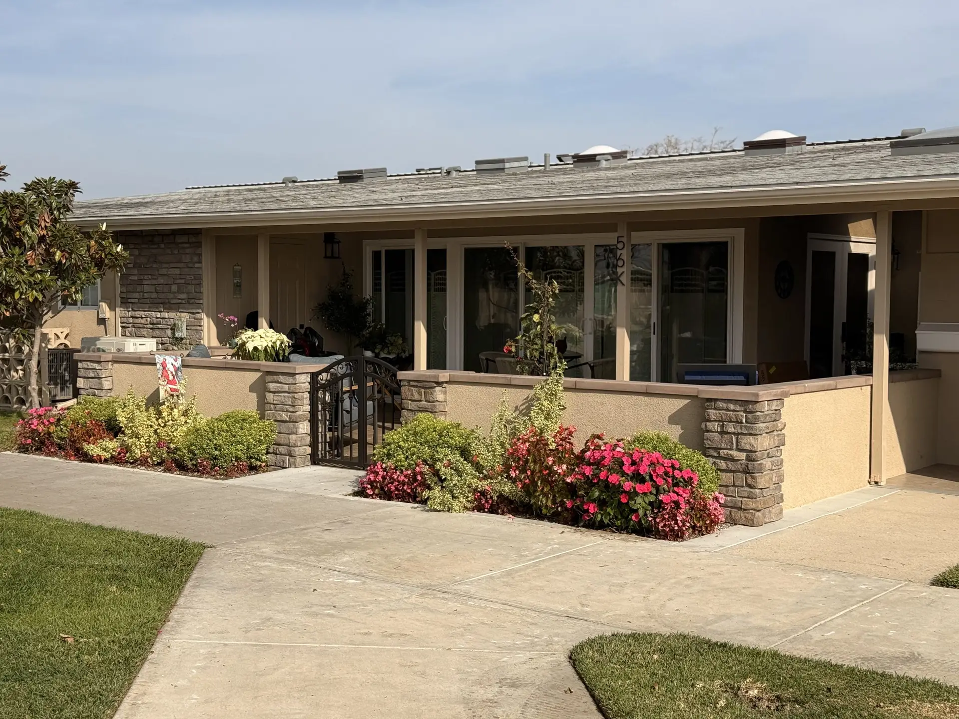 Front view of a Leisure World Seal Beach home with landscaped garden, stone accents, and a welcoming entrance, reflecting typical residential styles in the community.