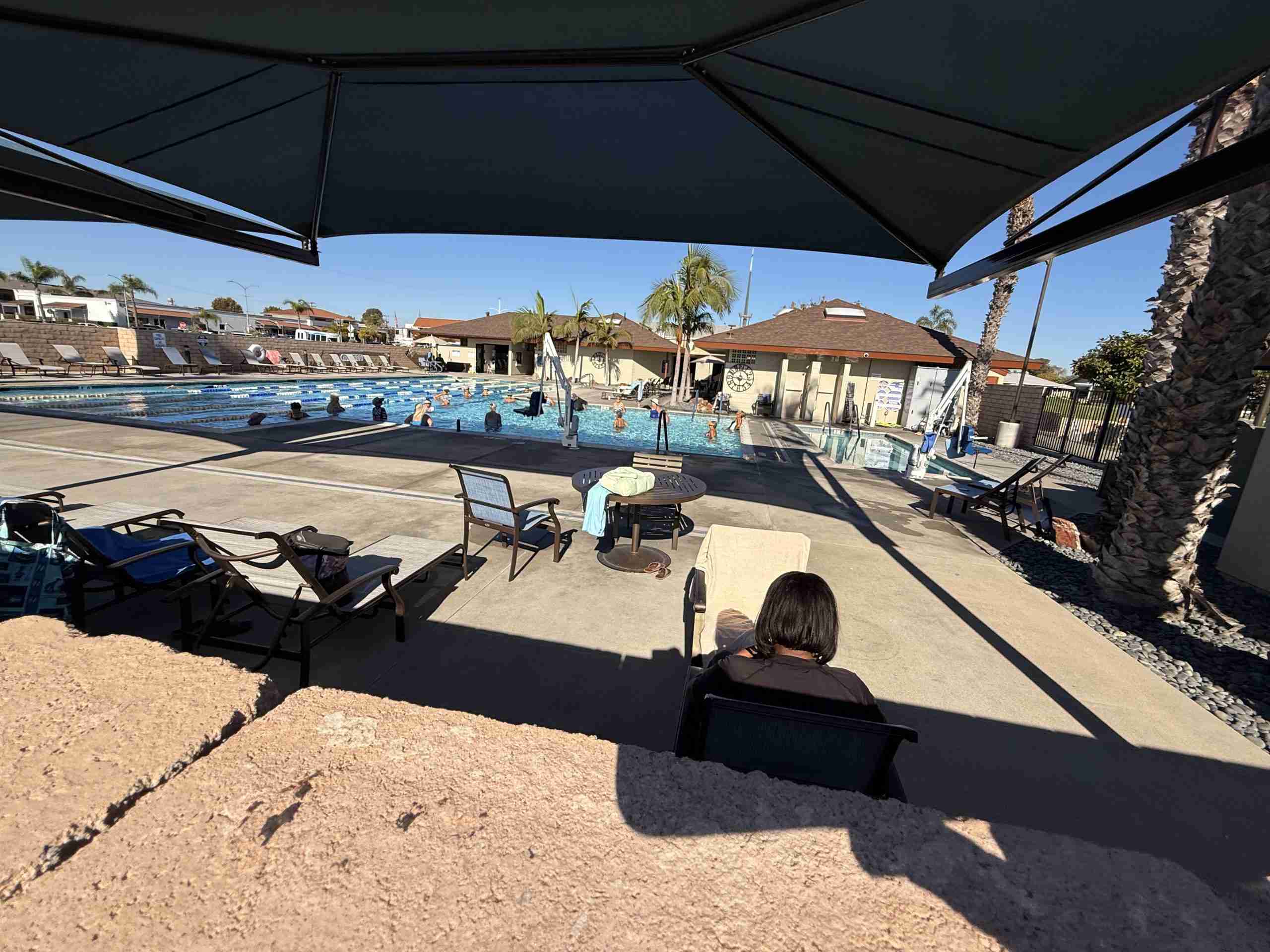 Leisure World Seal Beach community pool and patio area with lounge chairs and tables.