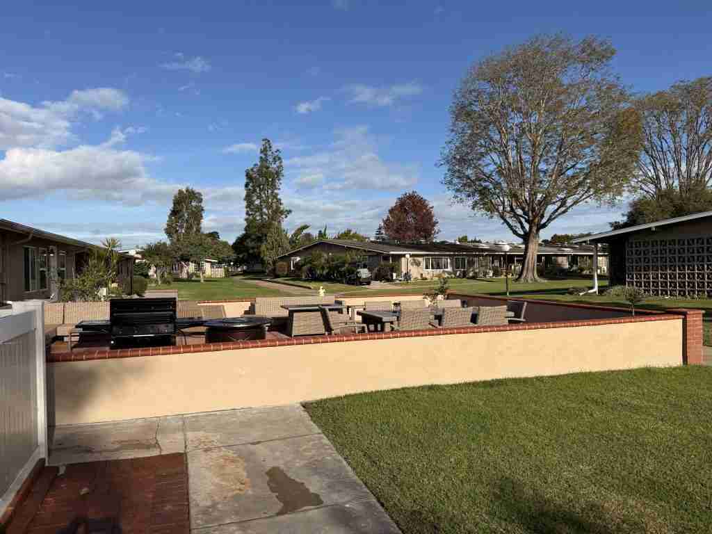 Well-maintained Leisure World Seal Beach community with patio and landscaping, showcasing curb appeal for 55+ buyers.