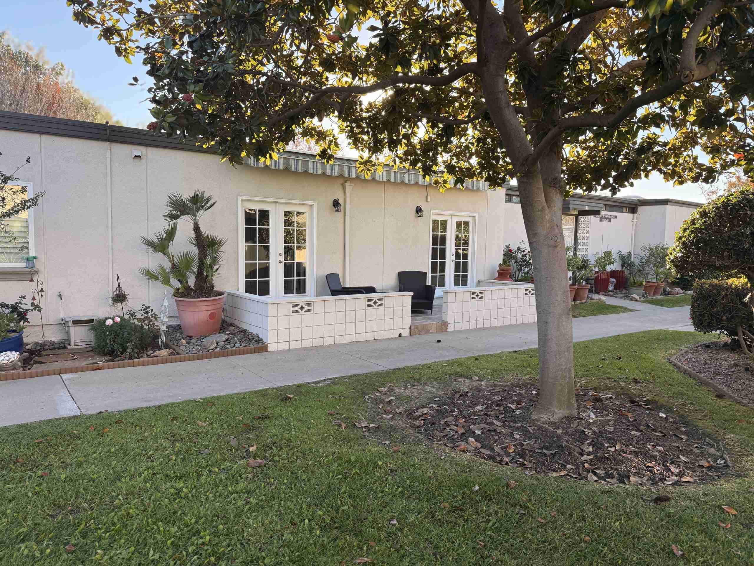 Leisure World Seal Beach home with landscaped yard and patio, showcasing 55+ community living.
