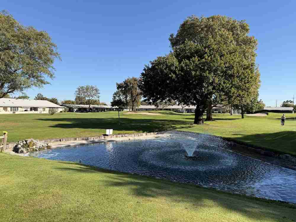 Leisure World Seal Beach golf course and pond with mature trees and resident-owned mutual living.