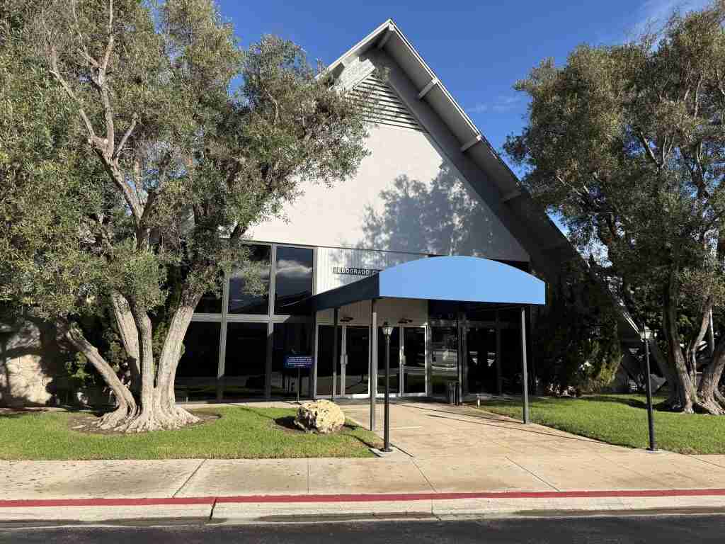 Mutual 10 clubhouse with covered entrance and landscaping, supporting active senior lifestyles in Leisure World, Seal Beach, CA.